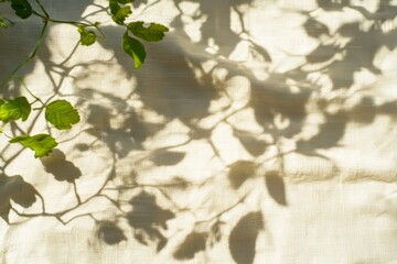 Fototapeta premium Aesthetic summer wedding bohemian background featuring beige linen fabric with folds and natural floral shadows from sunlight