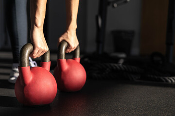 Athletic bodybuilding sport woman squat with kettlebell fitness training at gym.