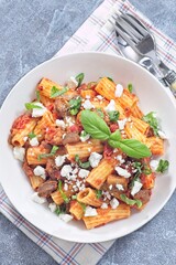 Rigatoni alla Norma pasta with eggplant, tomato, basil and ricotta salata, horizontal top view