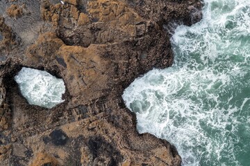 Ocean waves crashing against rocky coastline, creating a natural pool. Powerful sea action. Thor's Well, Yachats, Oregon, USA