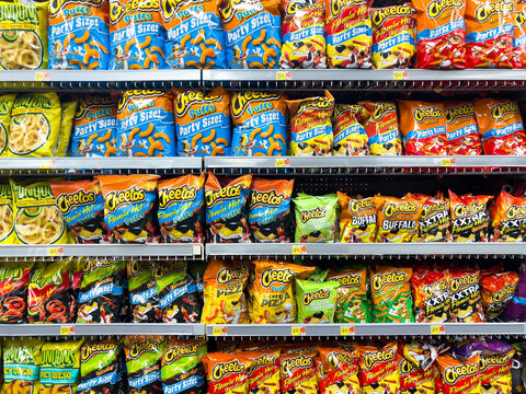 Full frame image of Cheetos brand snacks for sale at a supermarket shelf