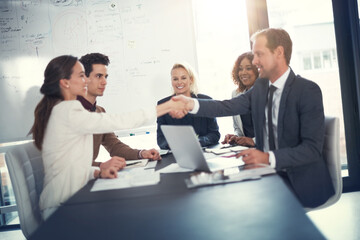 Business people, happy and handshake in office for deal, sales agreement and corporate collaboration. Investors, laptop or shaking hands in agency for new partnership, opportunity and team commitment
