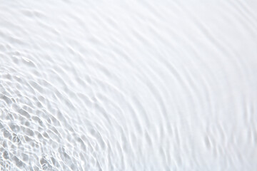 Obraz premium Rippled surface of clear water on white background, top view