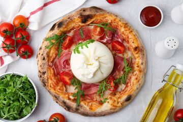 Delicious pizza with burrata cheese served on light grey table, top view