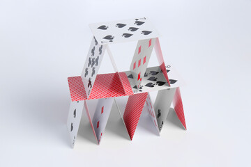 House of playing cards on white background