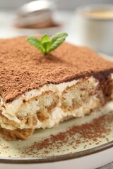 Piece of tasty tiramisu on table, closeup