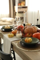 Stylish table setting with beautiful autumn decor in dining room