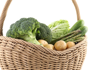 Different ripe vegetables in basket isolated on white
