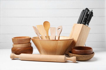 Dishware and cooking utensils on white table
