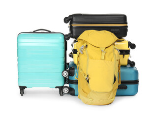 Many colorful suitcases and backpack isolated on white