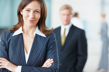 Portrait, business and woman with confidence in office of corporate leadership, about us and experience. Smile, female person and arms crossed for finance ambition, investment funding and opportunity