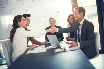 Business people, smile and handshake in office for deal, sales agreement and corporate collaboration. Investors, laptop or shaking hands in agency for new partnership, opportunity and team commitment