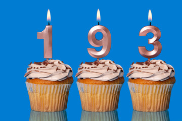 Birthday Cupcakes With Candles Lit Forming The Number 193.