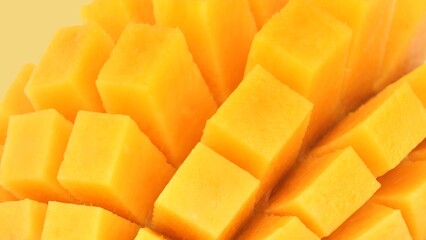 Close-Up of Ripe Mango Cubes on Yellow Background