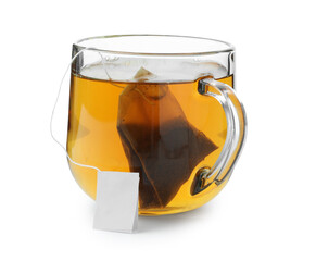 Tea bag in glass cup with hot drink isolated on white