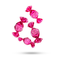 Candies in bright wrappers falling on white background