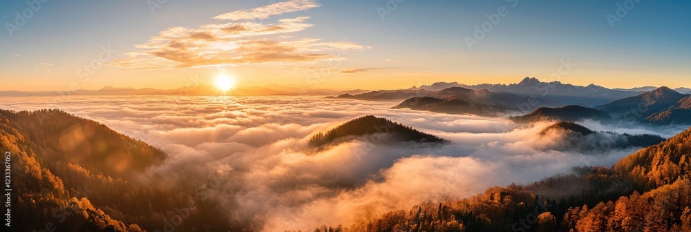 Aufkleber The sun is setting over a mountain range with a thick layer of fog