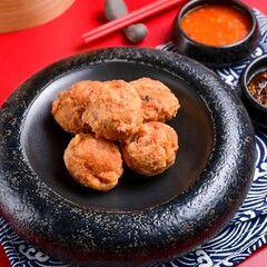 Bakso goreng (crispy meatballs) are deep-fried Indonesian meatballs with a crunchy exterior and tender interior, often served with spicy sauce for a flavorful snack or appetizer.