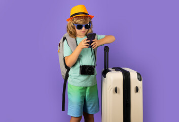 Child with travel suitcase on vacation. Kids travel and adventure concept.