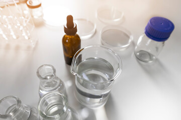 Clear bottles and dishes are used in scientific and medical experiments.