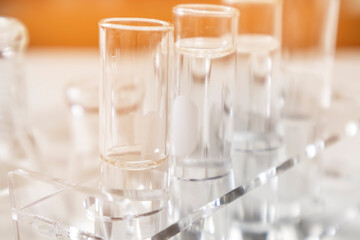 Clear bottles and dishes are used in scientific and medical experiments.