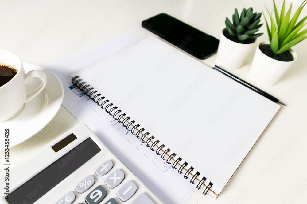 Fototapete blank white notebook with empty space in the middle. on the white table are a calculator and a mobil