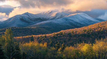 Fototapeta premium Snowy mountain peaks at sunset, autumn foliage.