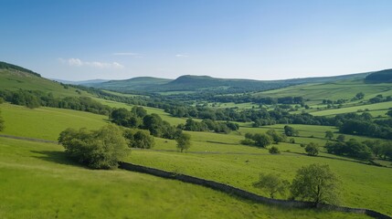 Obraz premium Vast Green Valley Landscape Under a Clear Blue Sky