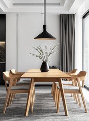 Modern dining room with wooden table, chairs, pendant light, and vase of branches.