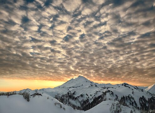 Ghost asperitas clouds over the mountains covered with glacier and snow at sunset. Mt Baker Ski Resort. WA. USA