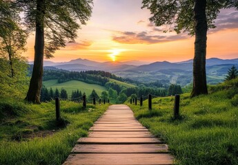 Wooden path leads to scenic sunset over rolling hills and mountains.