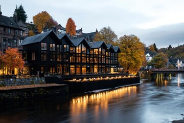 Obraz premium Modern Black Building By River With Autumn Trees