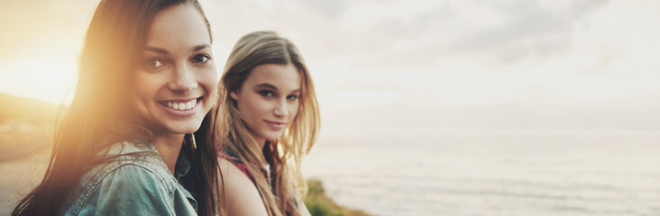 Travel, smile and view with friends in beach for explore, bonding and summer vacation. Sunset, mockup space and portrait with women and ocean for holiday, adventure and seaside banner with lens flare