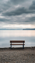 Solitude by the Lake: A Serene Bench Under a Cloudy Sky