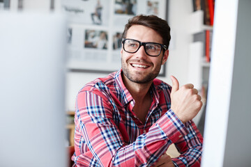 Man, employee and thumbs up for thinking in office, planning success and approval for business....