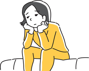 ソファに座って悩む女性