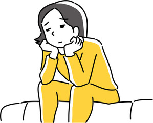 ソファに座って悩む女性