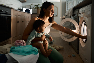 Home, baby and mom with machine for laundry, multitask late and stress for household chores. House,...