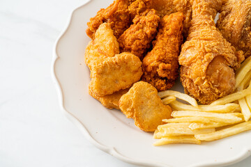 fried chicken with french fries and nuggets on plate