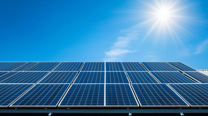 Obraz premium Solar panels installed on rooftop under bright blue sky, showcasing renewable energy technology. sun shines brightly, emphasizing importance of sustainable energy sources