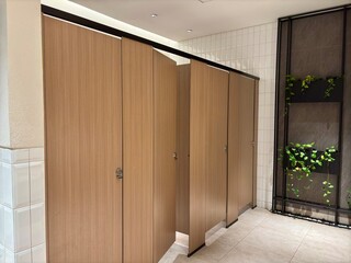A line of restroom in a mall. Restroom with a wooden door for guests at the mall.