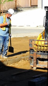 Engineer leveling ground with shovel