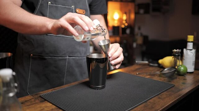 Bartender mixes daiquiri with simple syrup in cozy bar. Perfect for cocktail tutorials or beverage commercials.