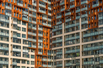 Modern residential building facade with geometric patterns and colorful accents in an urban...