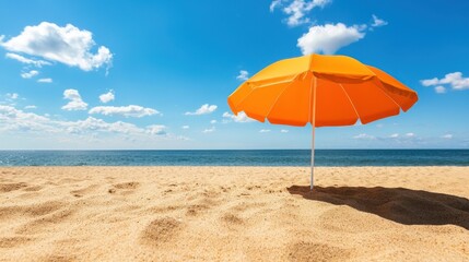 Fototapeta premium Bright Yellow Umbrella on Sandy Beach Under Clear Blue Sky with Gentle Waves in Background
