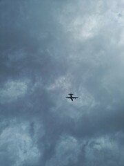 Bandung, Indonesia - Feb 1, 2025: Propeller airplane flying in the cloudy sky