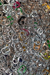 A pile of hundreds of drink tabs from aluminum soft drink (soda) and beer cans, removed and collected for recycling to raise money for charity.