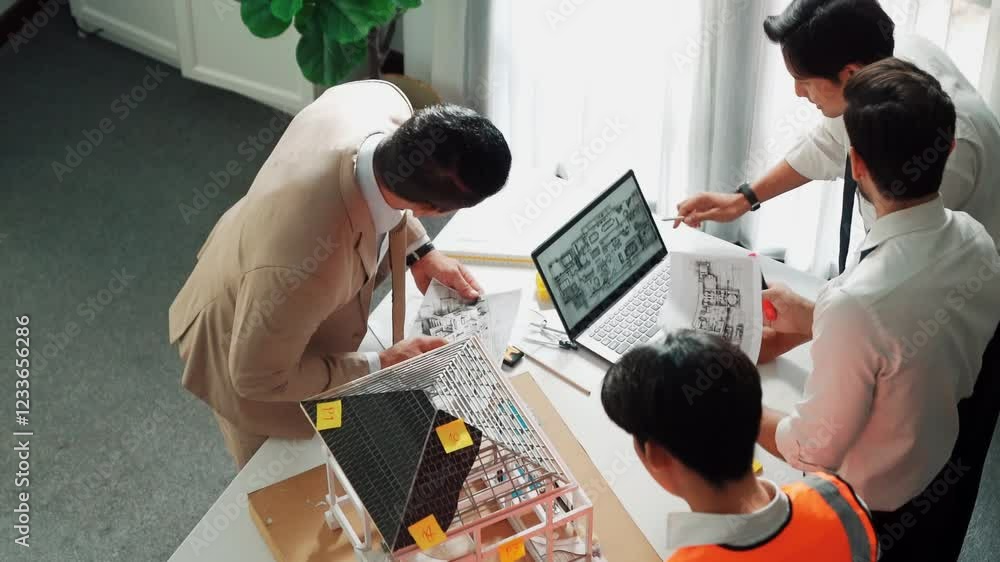Poster top view of professional architect engineer team inspect house model while manager holding blueprint