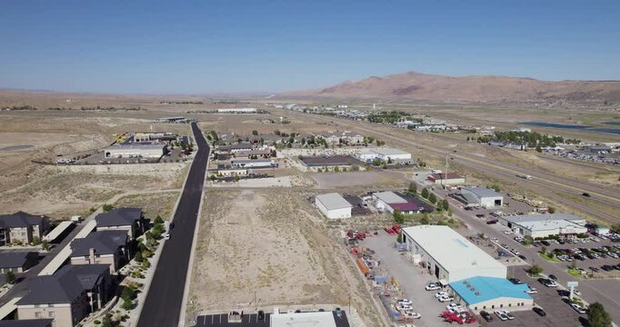Elko City With Ruby Mountain Range Background In Elko County, Northeastern Nevada. Aerial Drone Shot