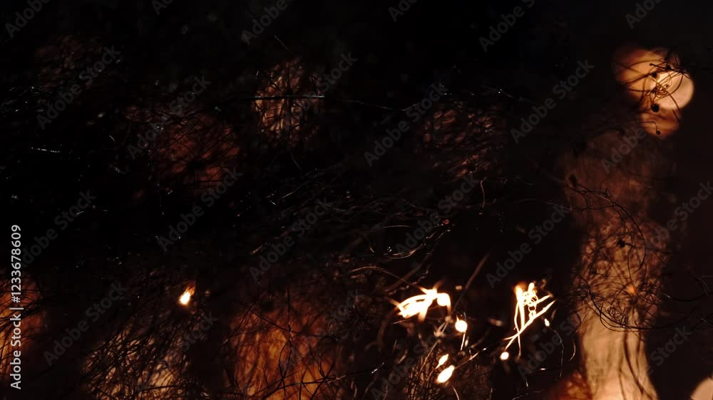 Poster flames burning through textured surface in a macro shot, creating intense glow and .movement
